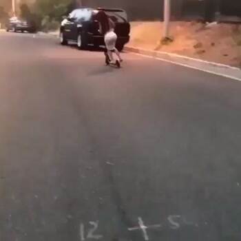 razor scooter wheelie in a skirt