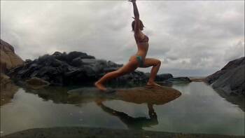 Showing off her yoga by the water