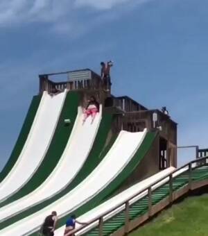 Just a fat guy having some fun on a water slide