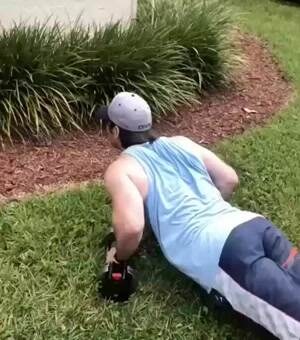 Lizard teaching human how to do push ups